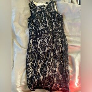 super cute black lace dress with a cream like base. worn a few times out.